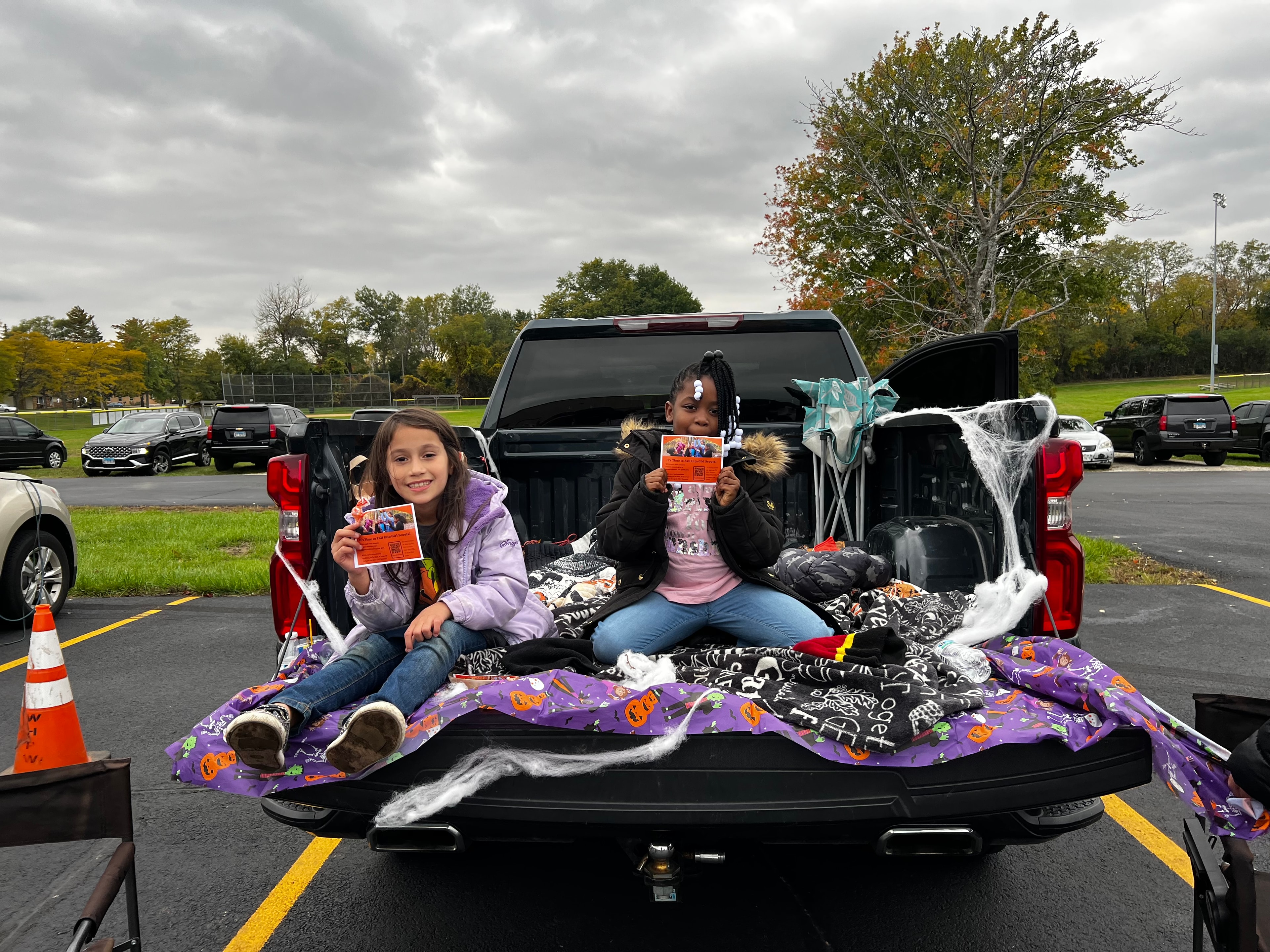 Two kids sitting in decorated truck bed